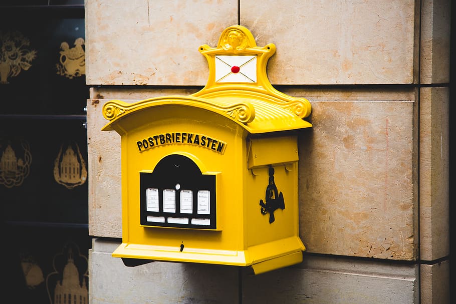 Yellow Postbriefkasten Floating Mailbox on Brown Concrete Wall HD wallpaper