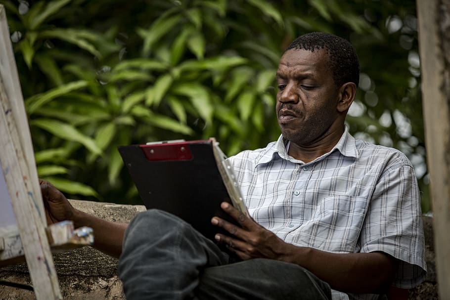 Reading policy. Man holding paper.