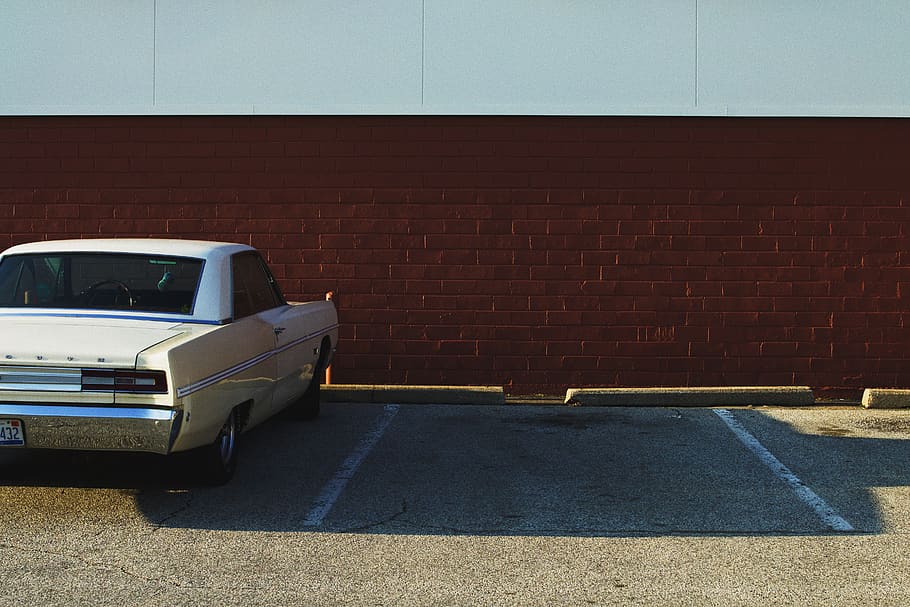HD wallpaper: white car parked on parking lot near brown and white wall