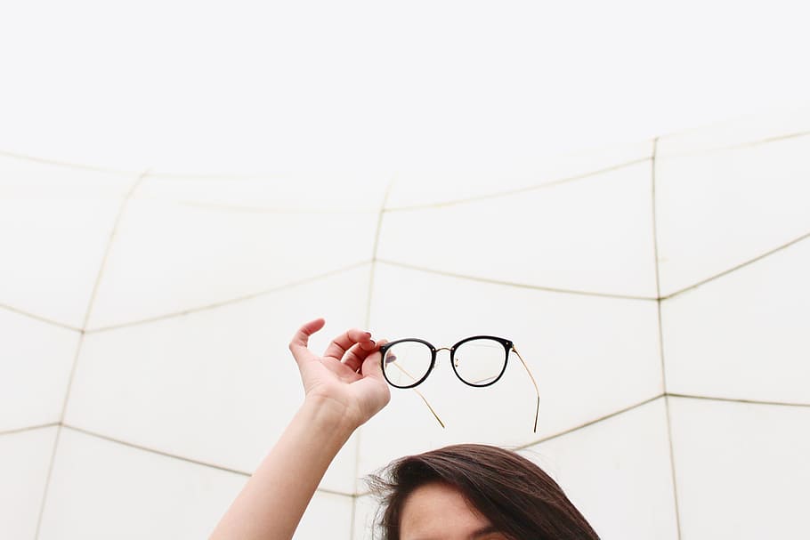 person holding black framed eyeglasses, minimalist, hand, reading glasses