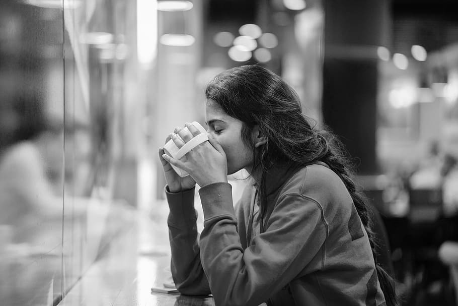 Sitting Woman Drinking Coffee, blurred background, bokeh, café