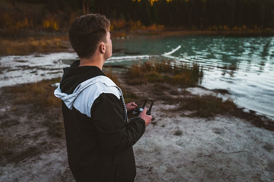 man holding drone controller, person, human, clothing, apparel HD wallpaper