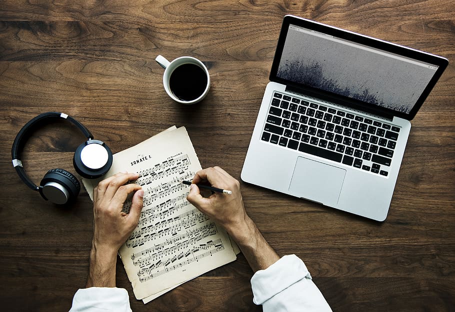 Person Writing Musical Notes Near Macbook, Cup of Coffee, and Black and White Headphones on Table, HD wallpaper