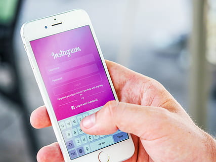 Person Holding Phone While Logging-in on Instagram Application HD wallpaper