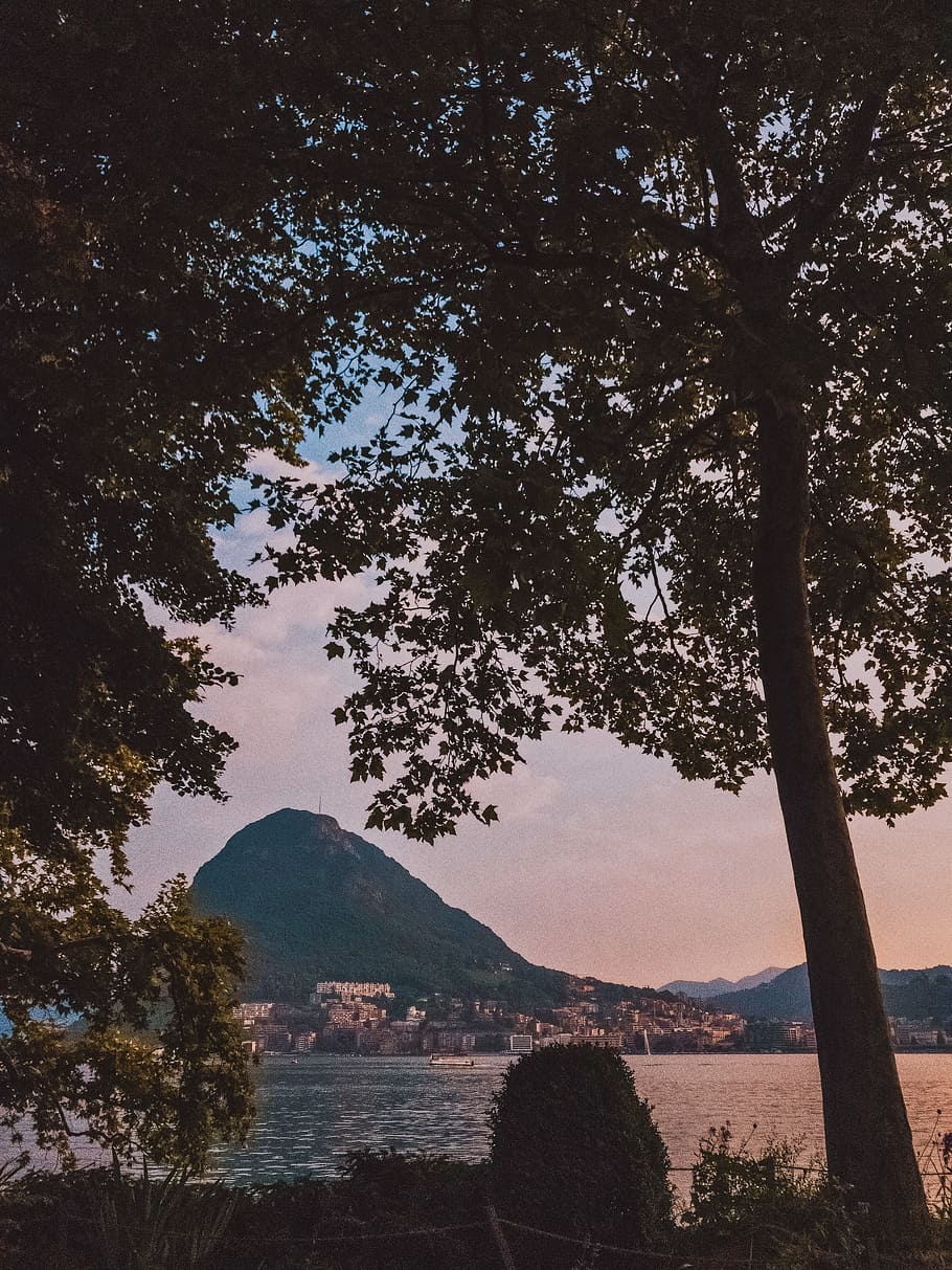 Silhouette Photography of City Near Body of Water and Mountain HD wallpaper