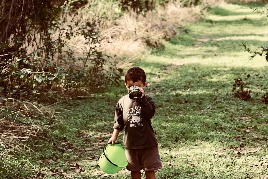 boy standing on green grass while drinking, person, people, human HD wallpaper