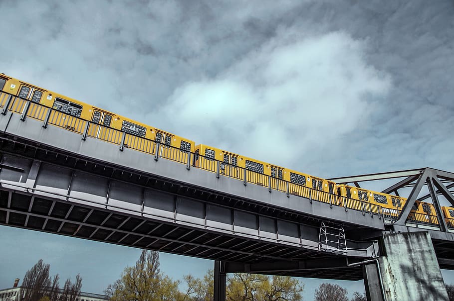 yellow train under gloomy sky, bridge, architecture, cloud - sky, HD wallpaper