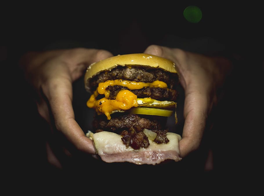 person holding hamburger, cheddar, restaurant, dinner, cheese