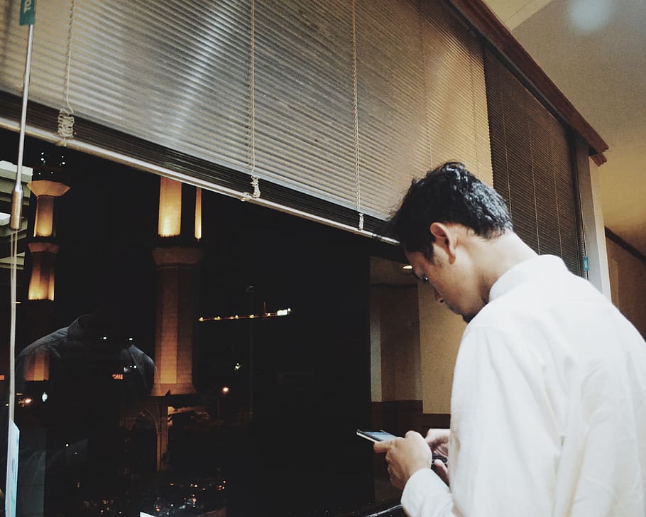 man using smartphone while face window, indonesia, menara bri bandung HD wallpaper