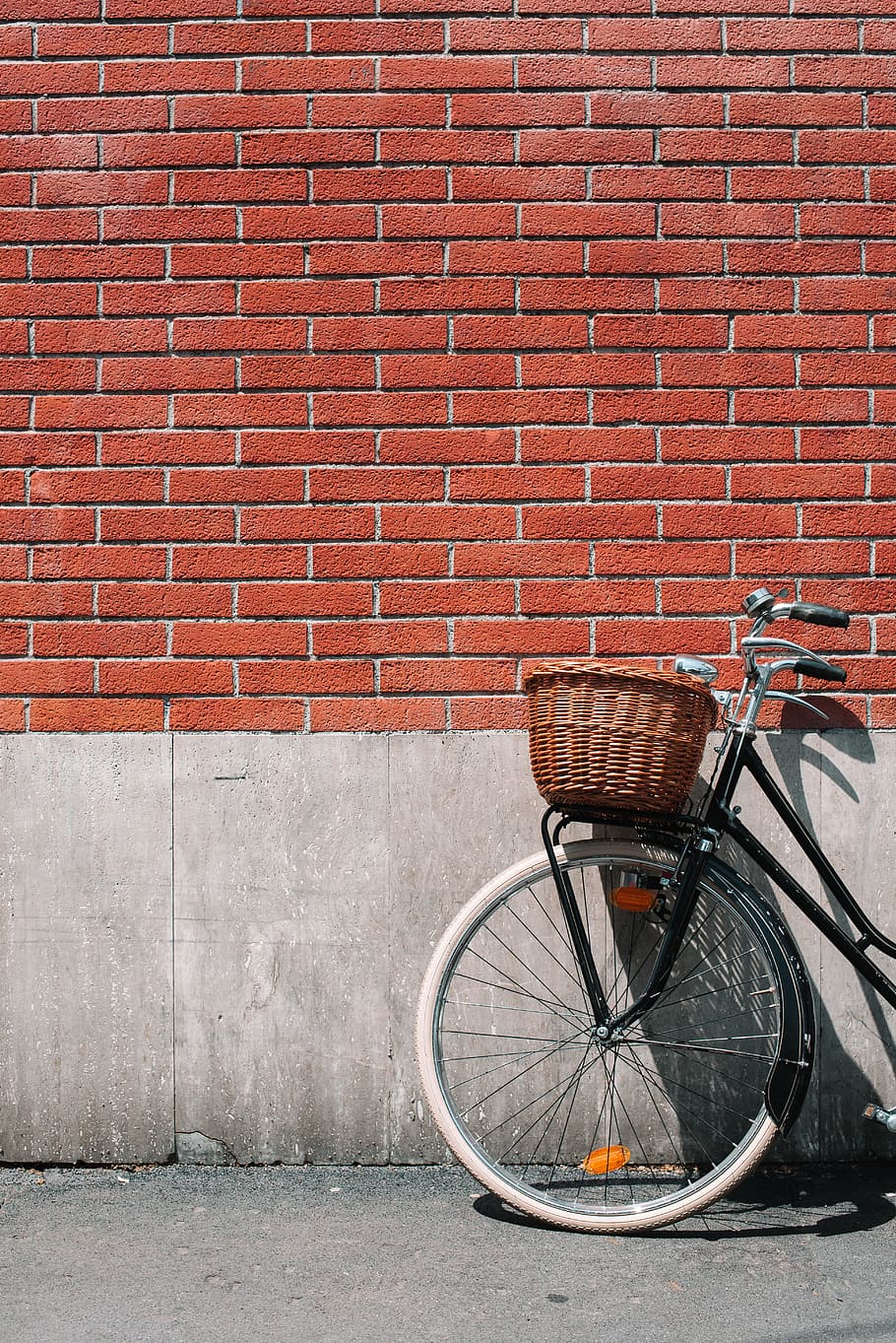 female beach cruiser bike on wall, bicycle, brick, red, sunlight