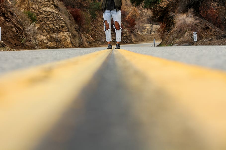 person walking on road, asphalt, jeans, route, feet, horizon, HD wallpaper