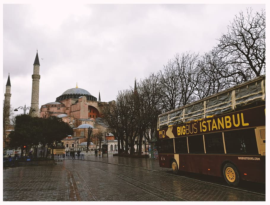 Brown Bigbus Istanbul Traveling on Road Near Brown Dome Building HD wallpaper