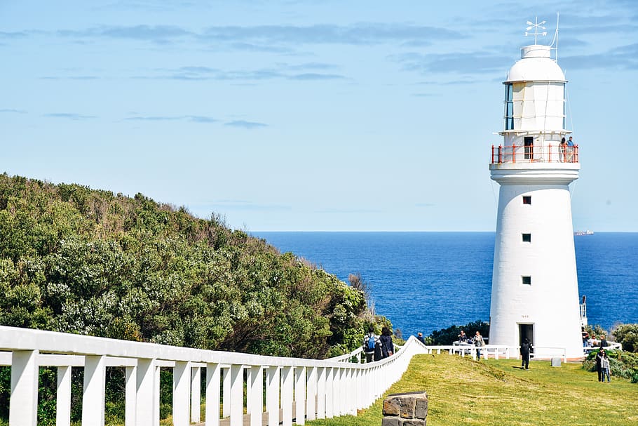 People Standing in Front of White Concrete Lighthouse during Daytime HD wallpaper