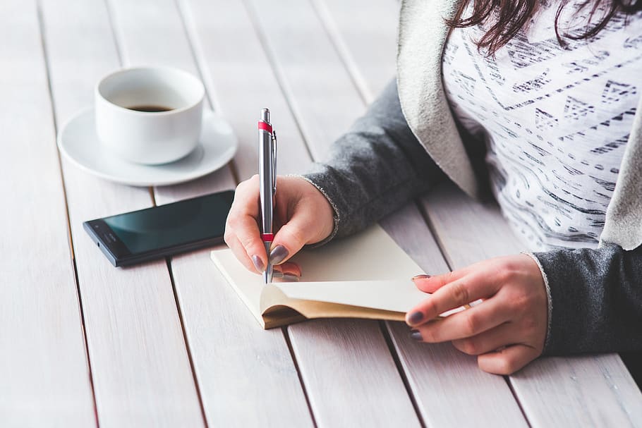Woman's hand using a pen noting on notepad, coffee, cup, hands HD wallpaper