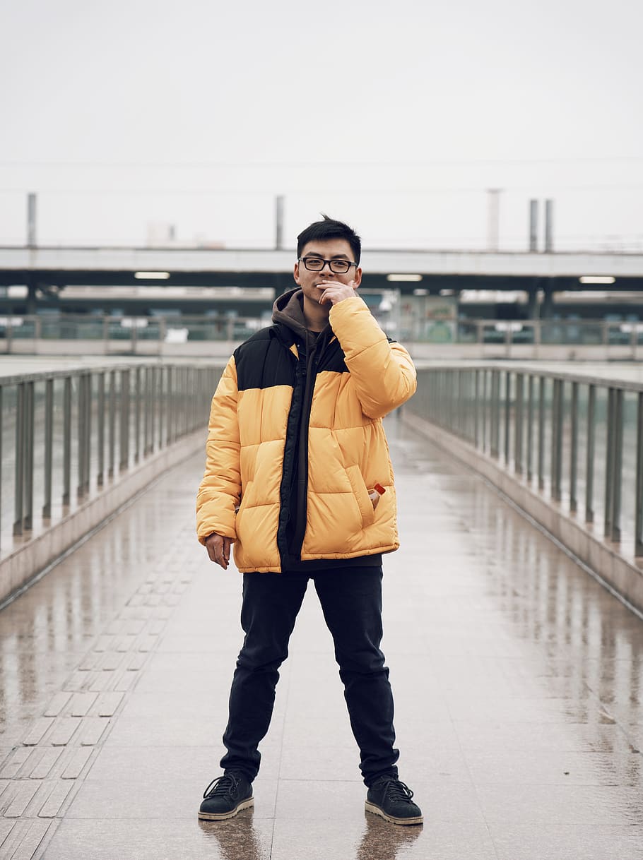 man wearing eyeglass standing in bridge during daytime, shoe, HD wallpaper