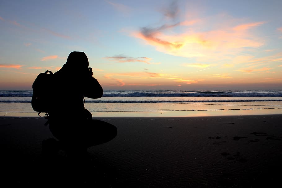 Silhouette of Person Taking Photo Near Ocean, clouds, man, sea HD wallpaper