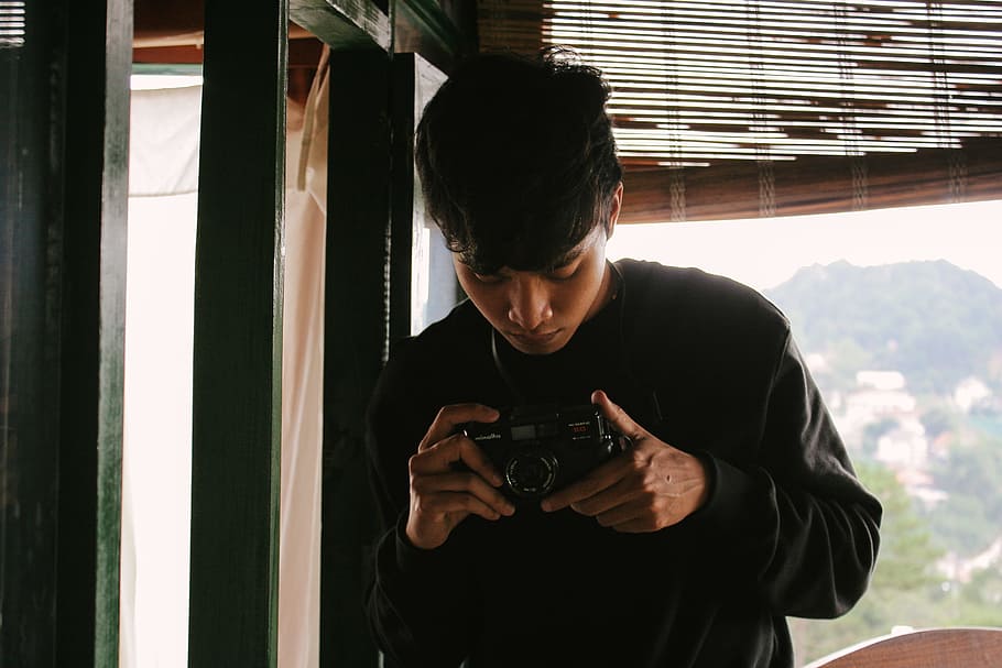Close-Up Photo of Man Holding Vintage Camera, boy, capture, guy HD wallpaper