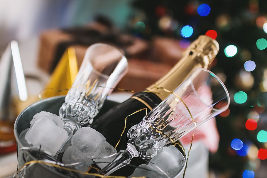 Selective Focus Photography of Brown Labeled Bottle and Two Clear Glass Champagne Flutes HD wallpaper