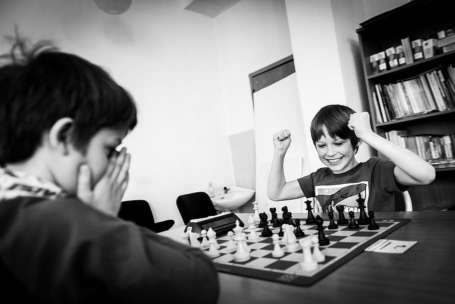 two boy playing chess grayscale photo, board game, leisure games