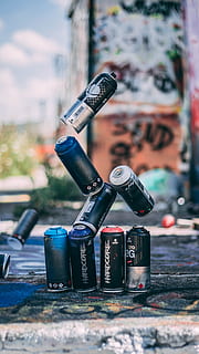 selective focus photo of flying spray paint cans o, float, levitation HD wallpaper