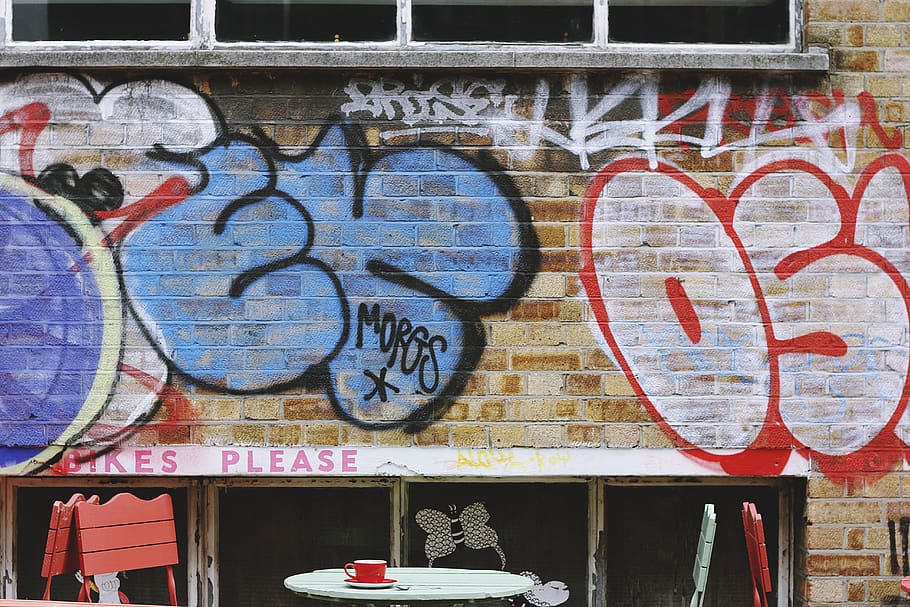 wall, bricks, paint, vandal, art, letters, table, chairs, cup HD wallpaper