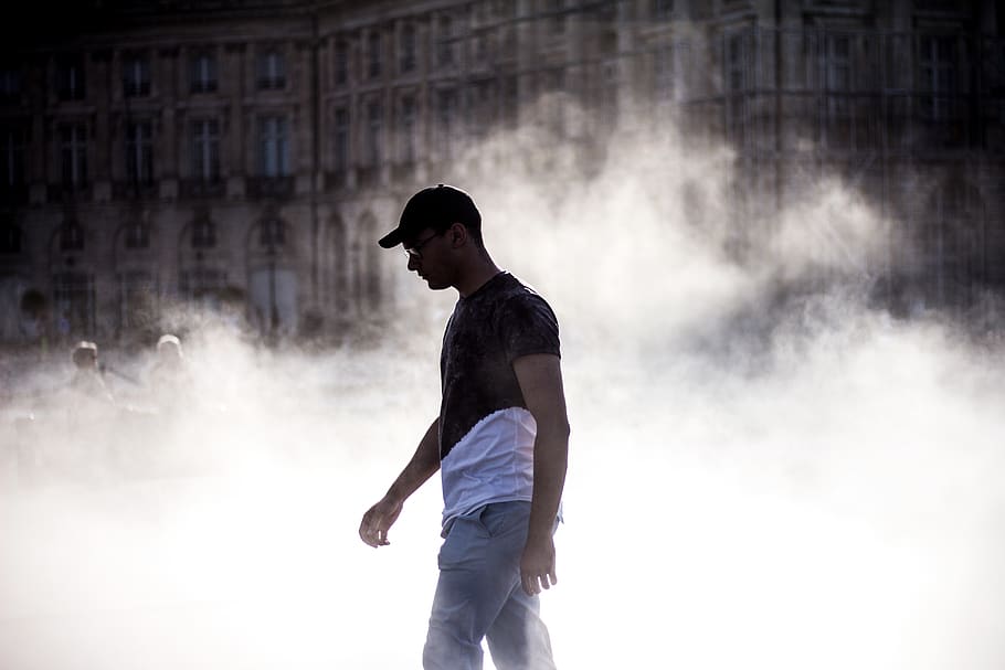 man walking by smoke, one person, young adult, standing, casual clothing HD wallpaper