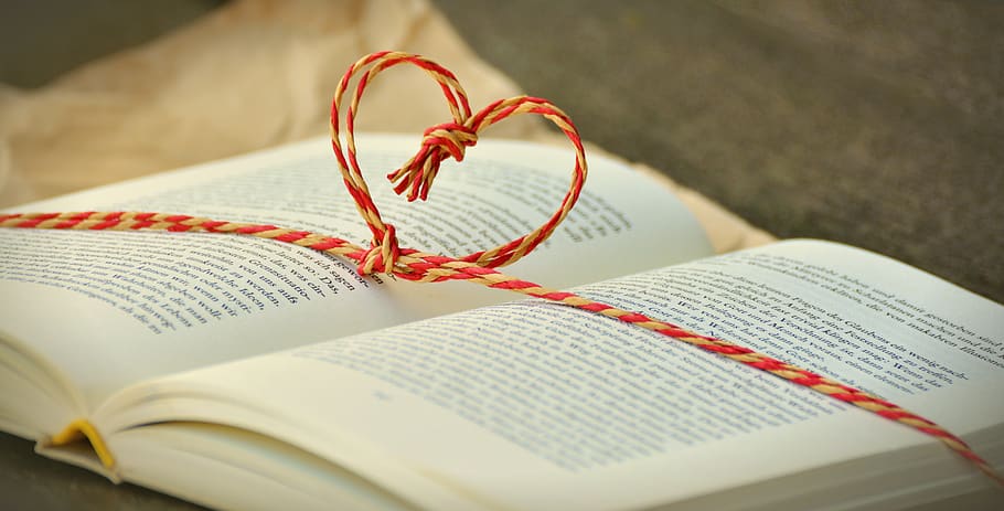 Tied Red and Beige Heart Knot on Opened Book Selective Focus Photo HD wallpaper