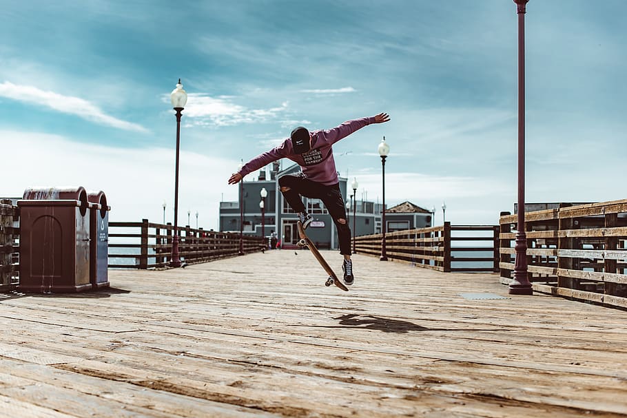 man playing skateboard, boardwalk, water, waterfront, building HD wallpaper