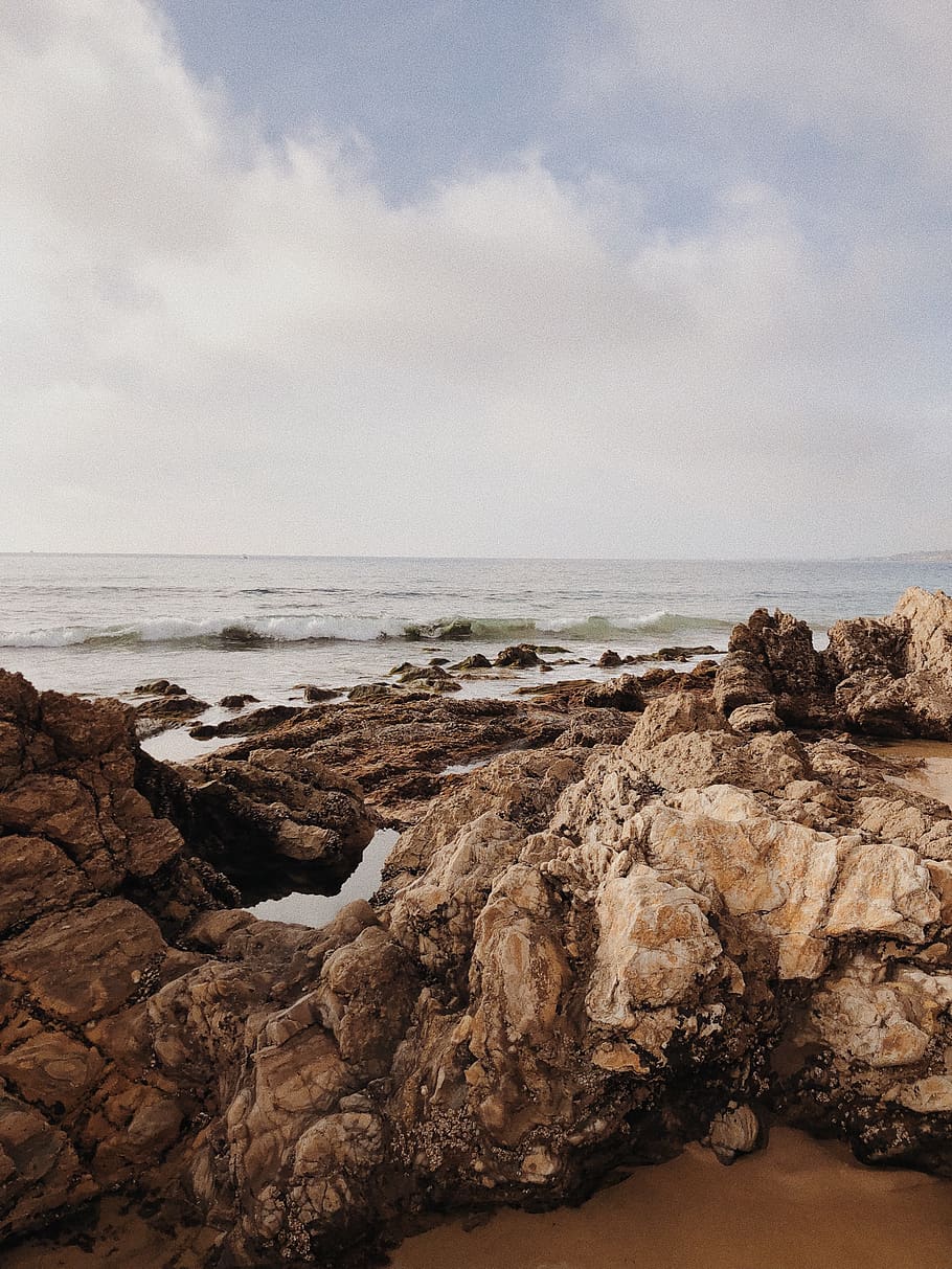 brown rocks beside beach, promontory, cliff, outdoors, nature HD wallpaper
