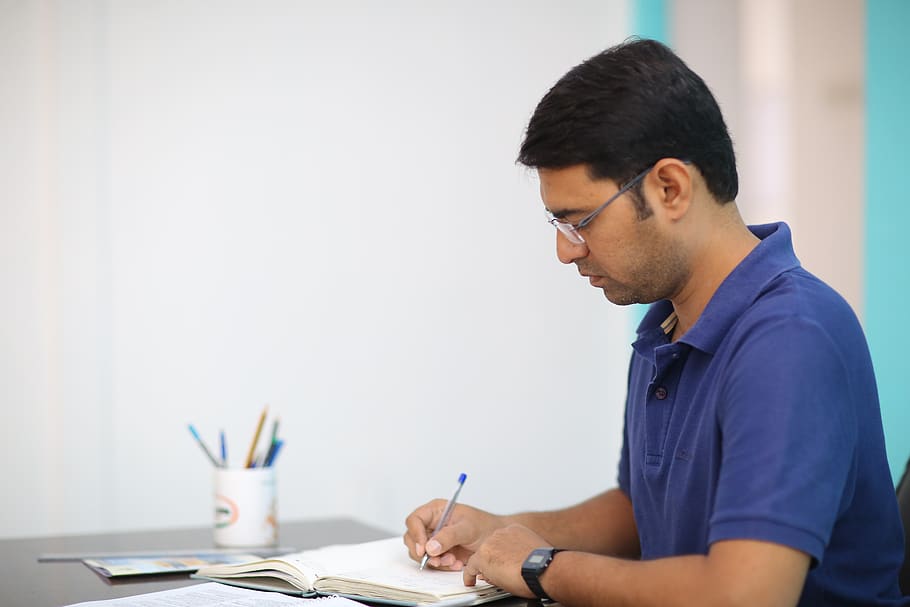Man in Blue Polo Shirt Writing, adult, composition, concentration HD wallpaper