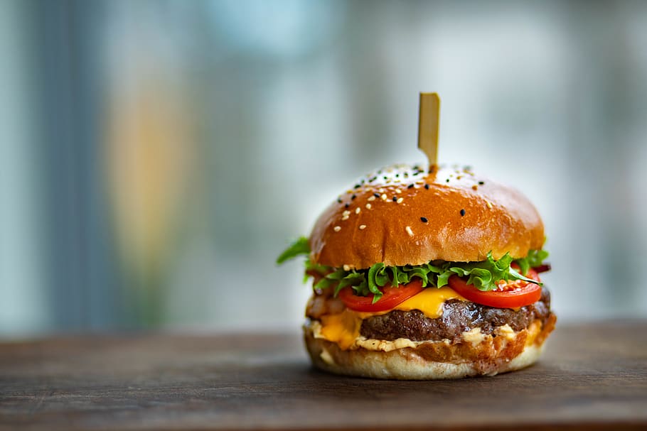 Photo of Juicy Burger on Wooden Surface, close-up, delicious