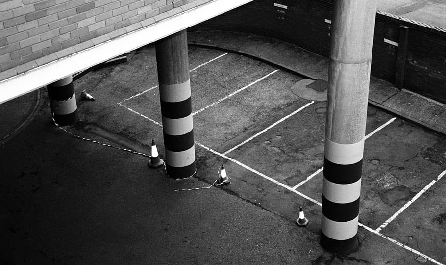 grayscale photography of building pillars, tarmac, asphalt, road