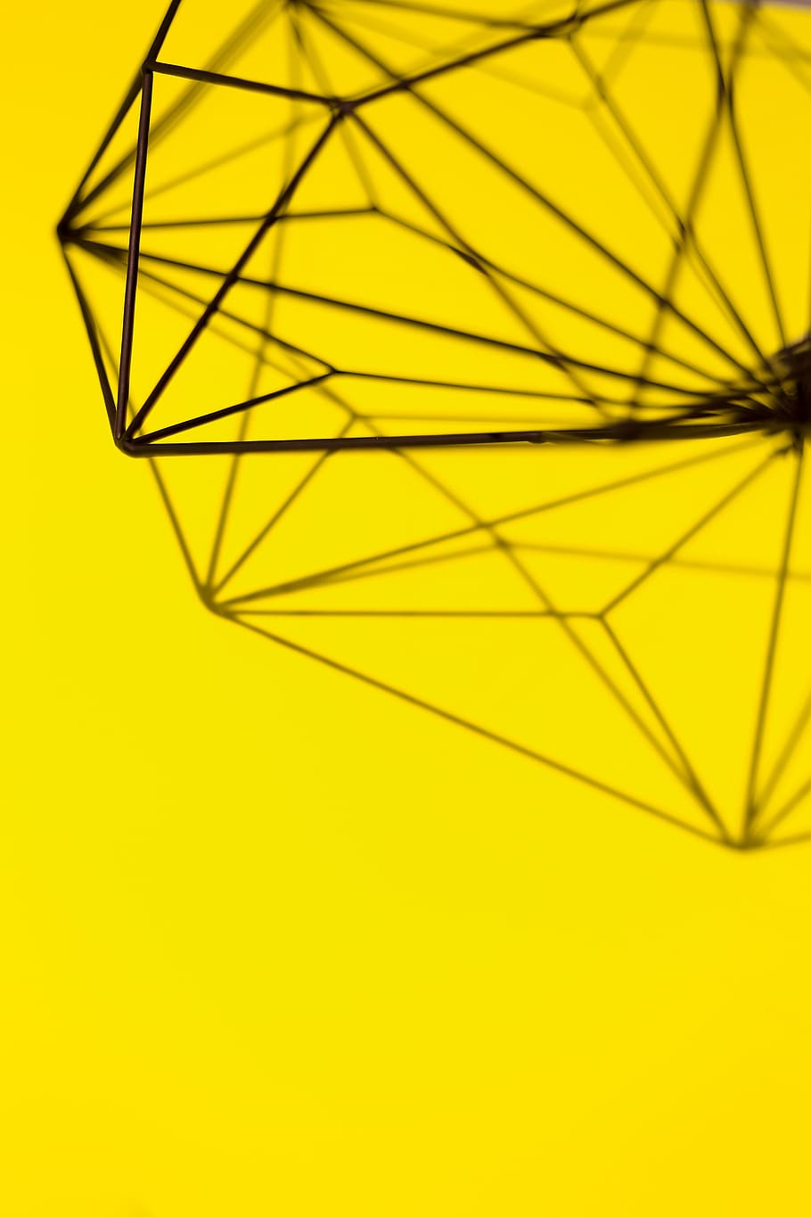 Geometric decoration on yellow background, texture, studio shot HD wallpaper