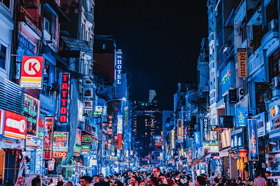 people between city buildings at night, neonlight, nikonphoto