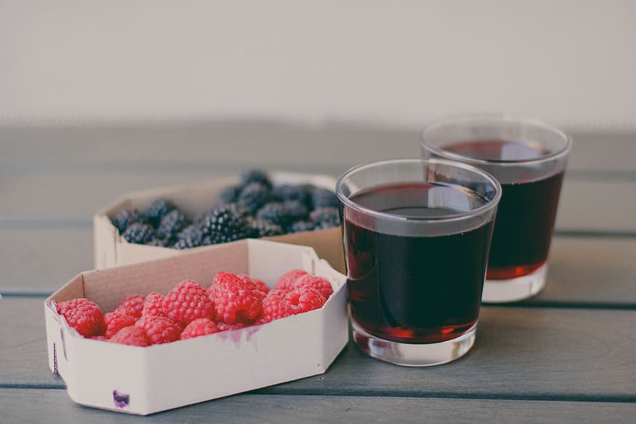 Two Drinking Glasses Filled With Raspberry and Blueberry Fruit Juices HD wallpaper