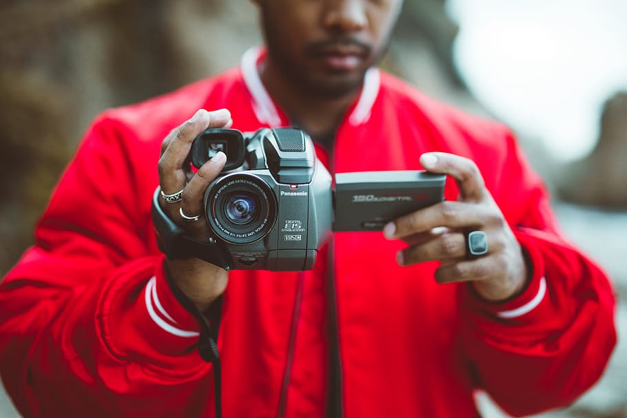 man holding camcorder, human, person, electronics, camera, photo HD wallpaper