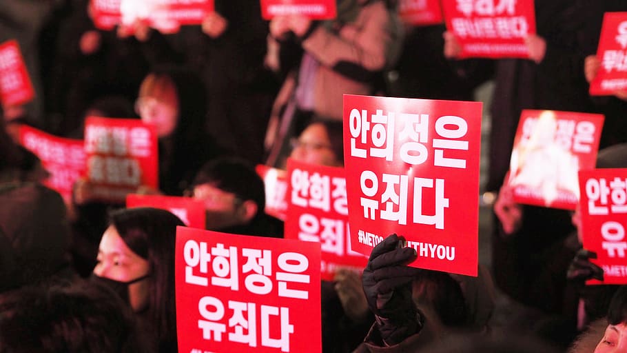 people holding red signages, person, human, crowd, vehicle, offroad