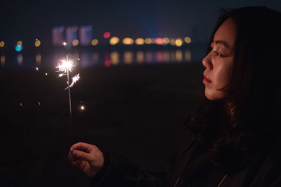 selective focus photography of woman holding sparkler, human, HD wallpaper