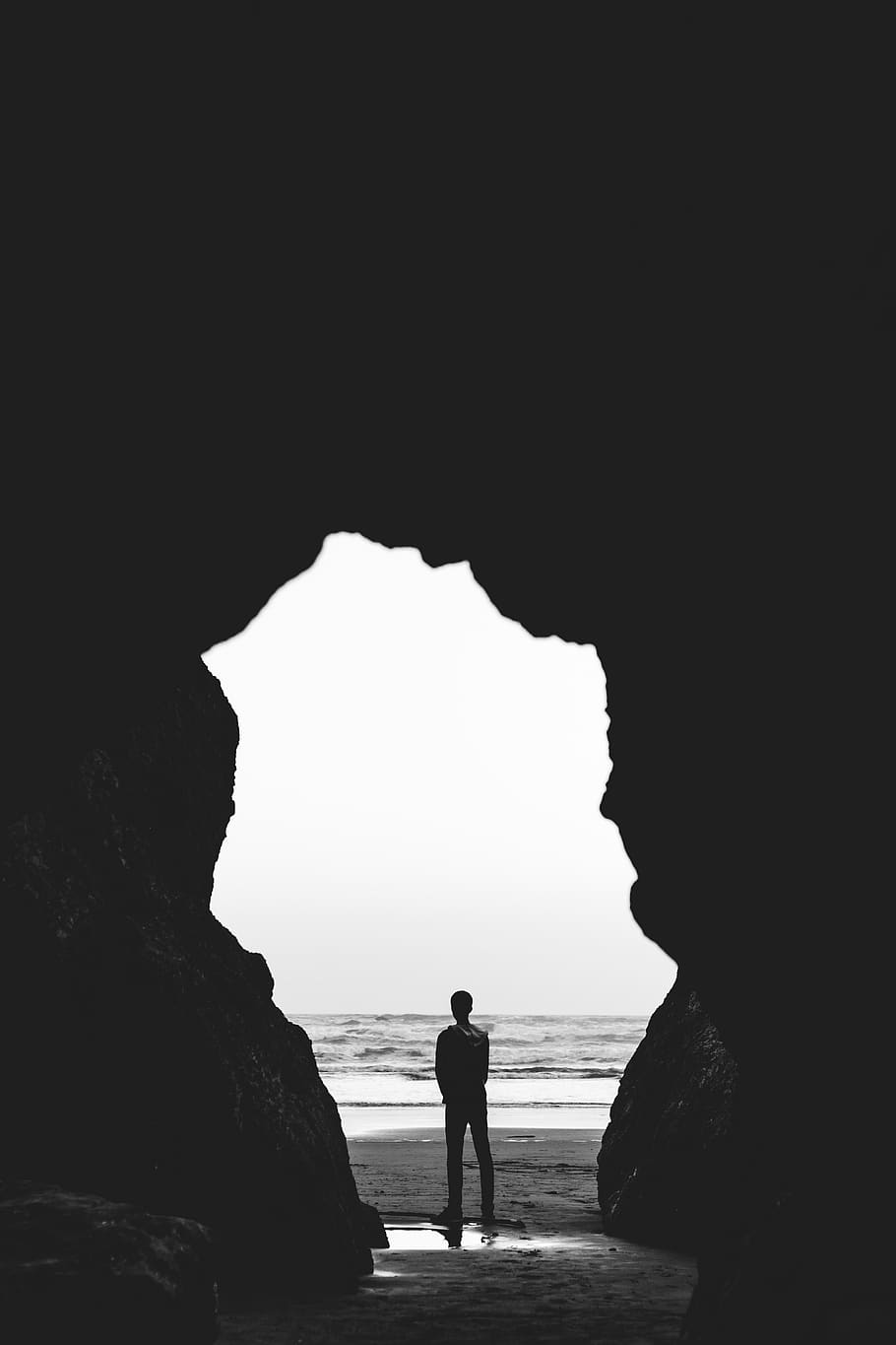 grayscale photography of man standing on seashore, cave, ocean, HD wallpaper