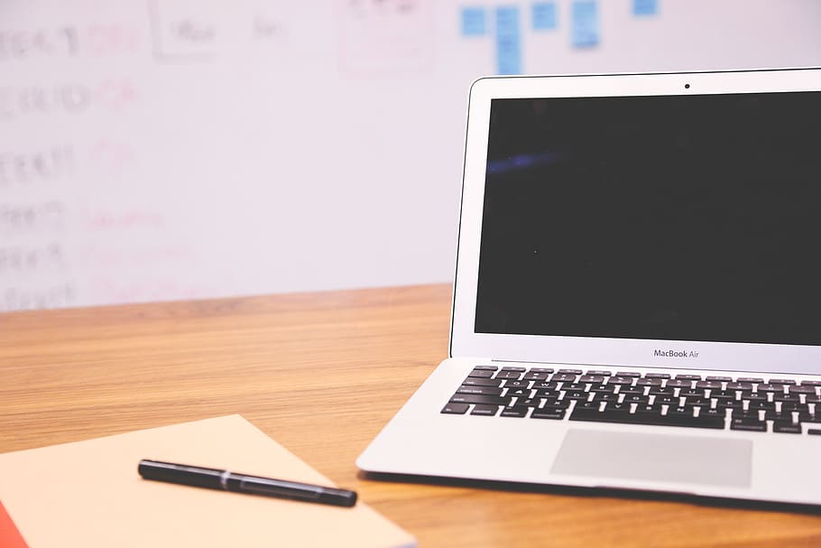 Turned Off Macbook Air Infront Black Ballpoint Pen on Brown Paper HD wallpaper