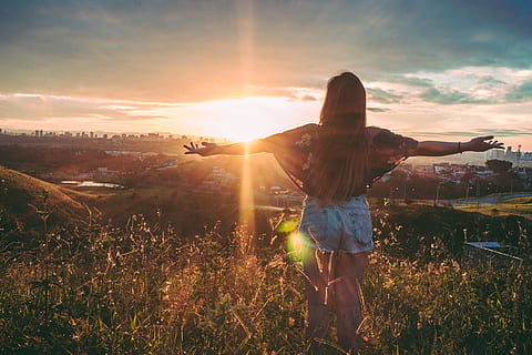 Woman Stands on Mountain over Field Under Cloudy Sky at Sunrise HD wallpaper