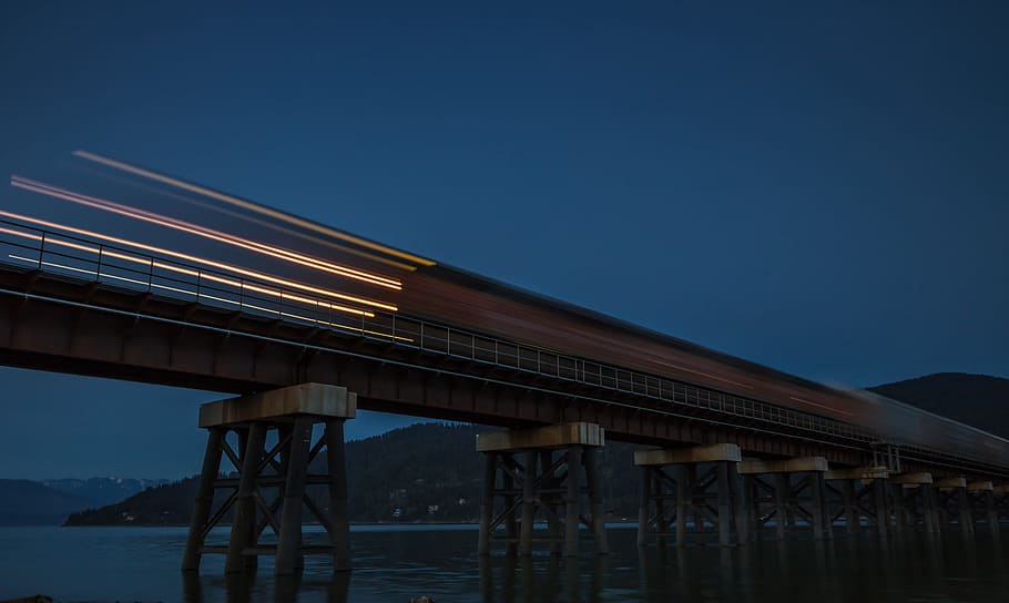 timelapse photo of train at nighttime, bridge, long exposure HD wallpaper