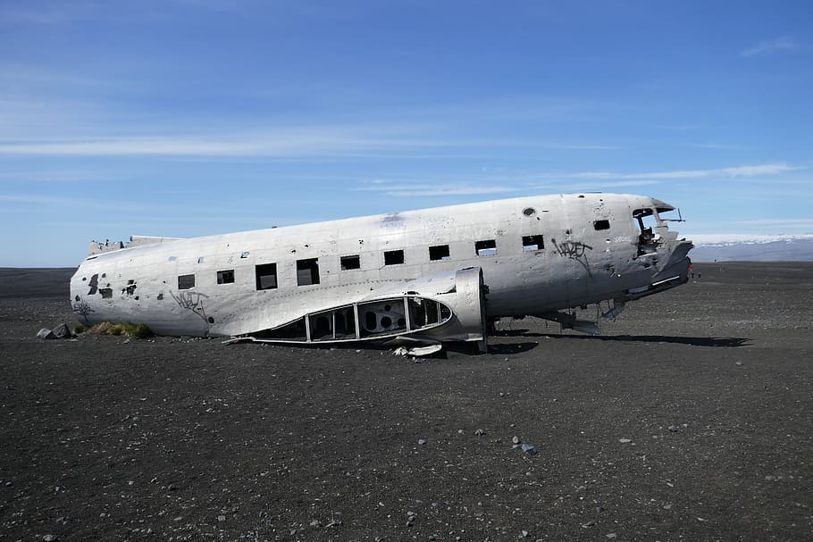 wrecked white plane on gray gravel, airplane, transportation