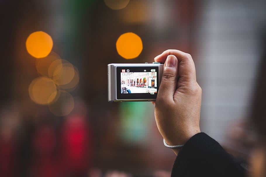 person holding digital camera, technology, wireless technology HD wallpaper