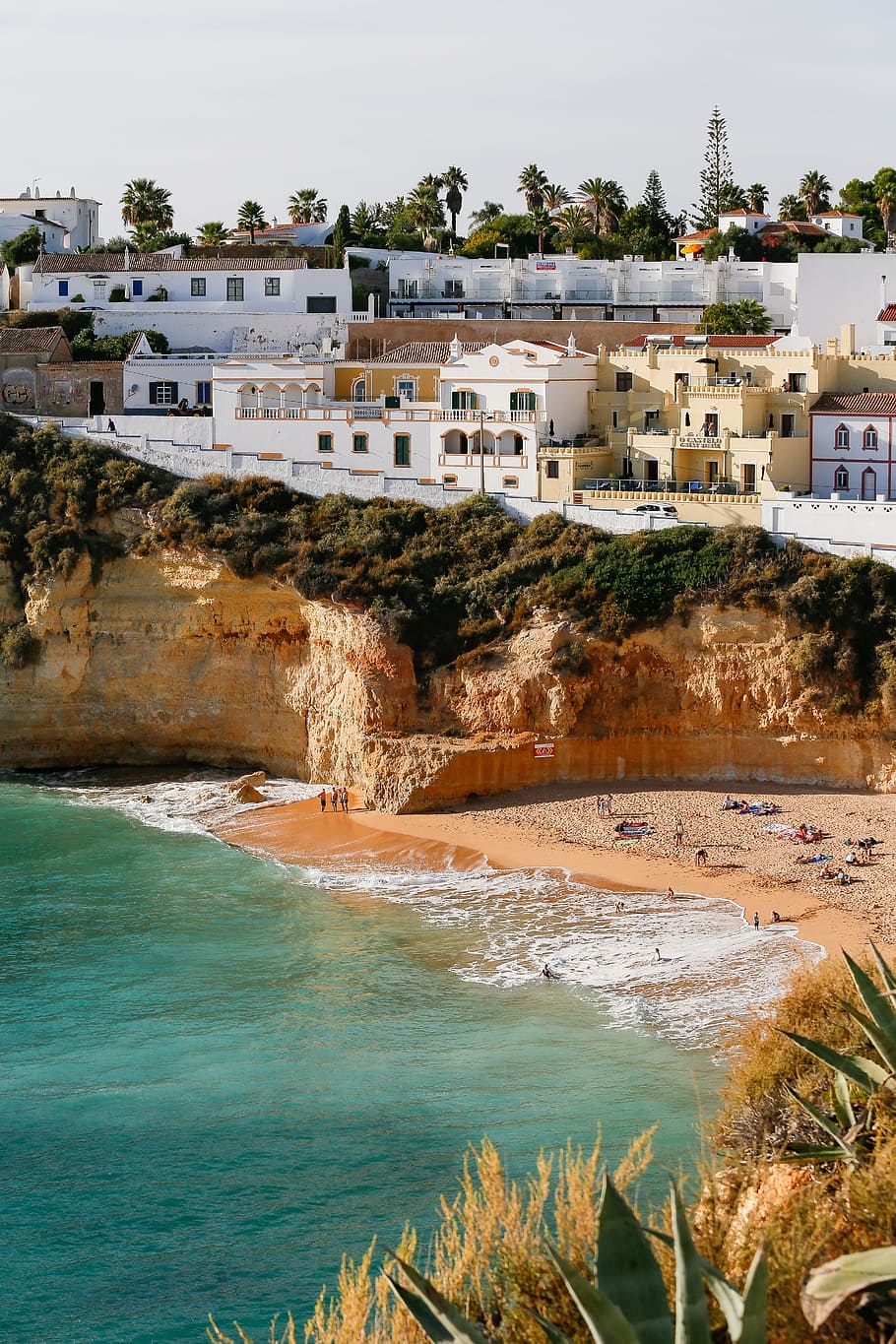 people sunbathing at the beach by the rock cliff, color, shadow HD wallpaper