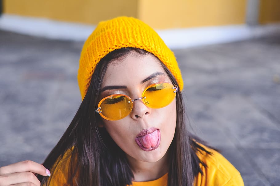 Photo of Woman with Her Eyes Closed Sticking Her Tongue Out, beanie