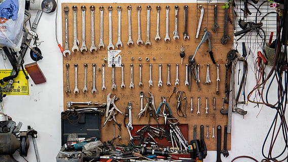 assorted-color tools on wall and table, person, human, people HD wallpaper