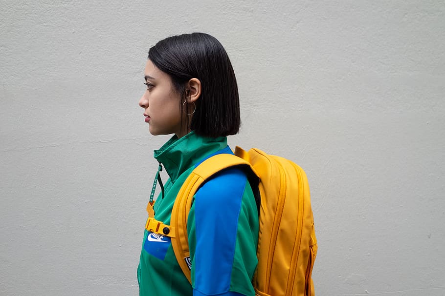 Woman Carrying Yellow Backpack, adult, side view, standing, hairstyle HD wallpaper