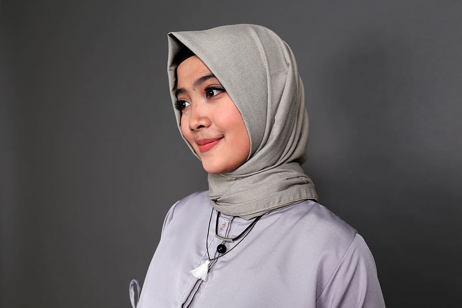 Smiling Woman Wearing Gray Hijab Beside Gray Wall, attractive