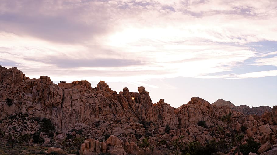 brown rock formation under dramatic clouds during daytime, nature HD wallpaper